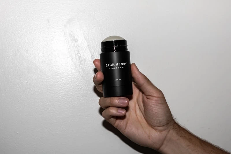 Jack Henry Deodorant with top off in hand