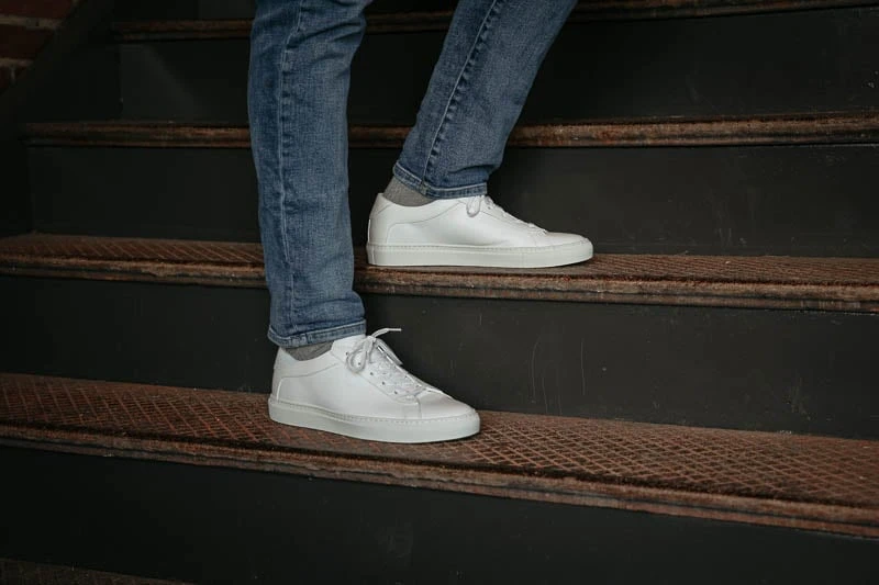 KOIO capri triple white sneakers on stairs