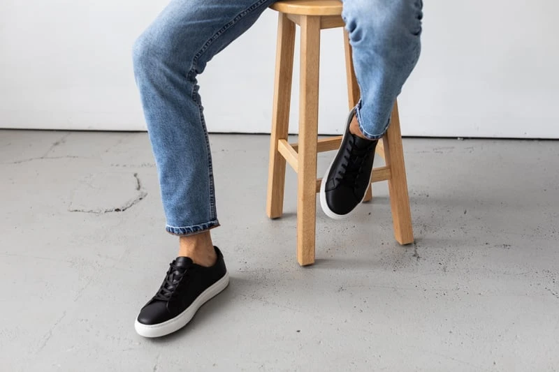 New Republic Kurt Leather Sneaker sitting on stool