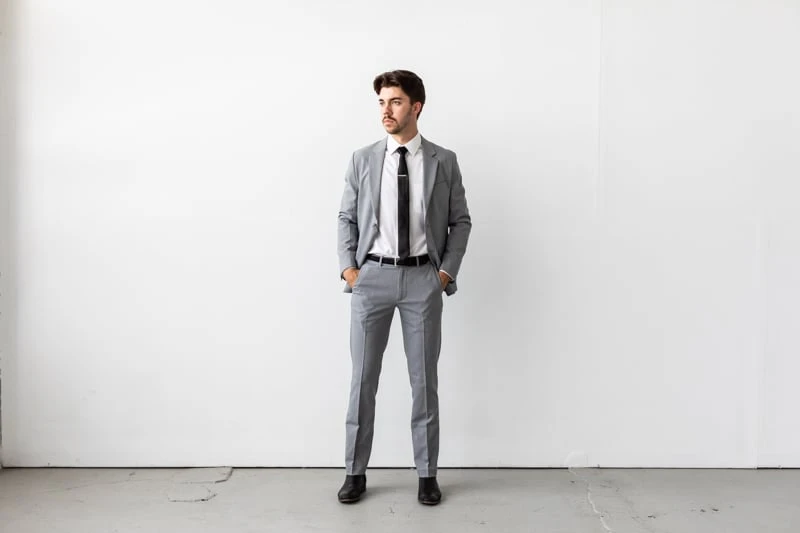 Bluffworks Presidio Blazer and Pants with jacket unbuttoned and hands in pockets