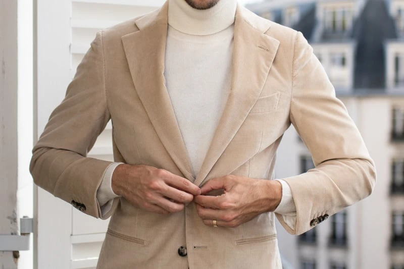 Suitsupply Custom Suit model on balcony buttoning suit jacket