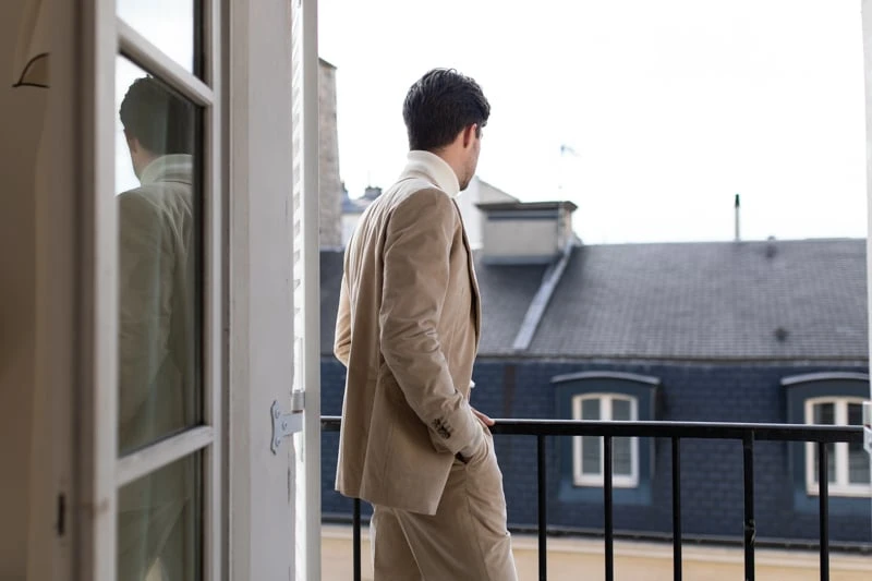Suitsupply Custom Suit model on balcony from over shoulder 1