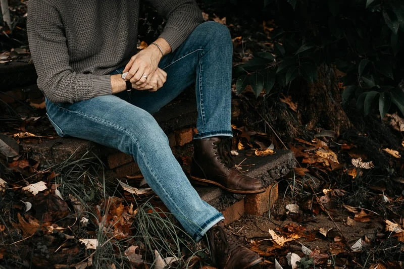 model with sweater and grey pants in the woods