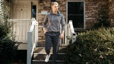 2023/01/What-to-wear-on-a-plane-Model-wearing-Lululemon-Outfit-Walking-Outside-of-His-House.jpgw3.webp