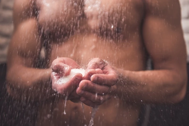 Afro American man taking shower