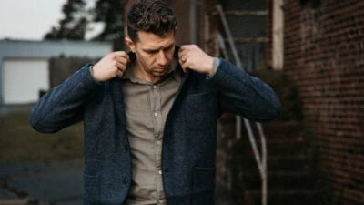 2023/04/Buck-Mason-Review-Model-Wearing-Chore-Coat-and-Draped-Twill-One-Pocket-Shirt.jpgw3.webp