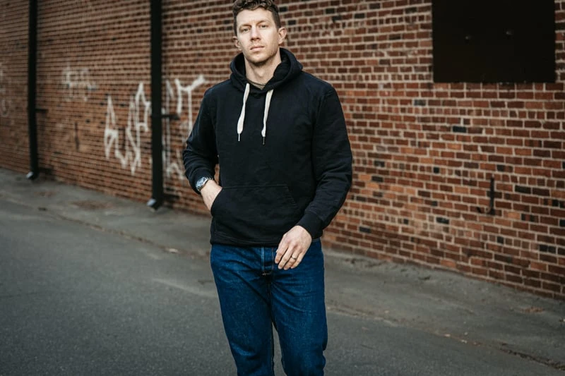 model wearing Buck Mason hoodie in black