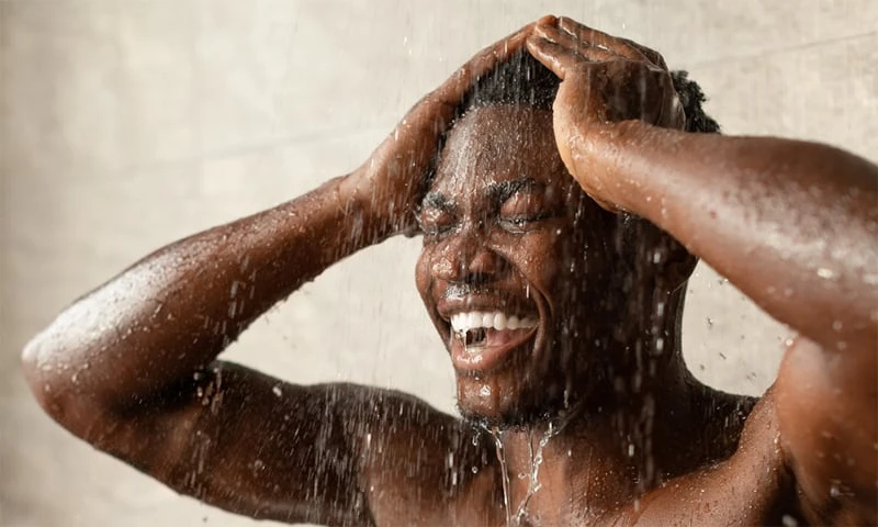 African American Man Washing His Hair in Shower