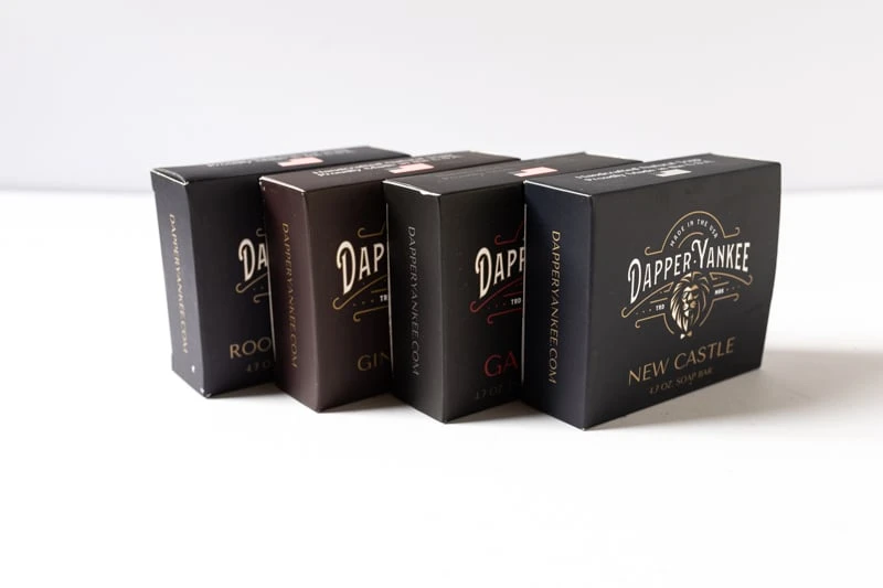 Dapper Yankee Review: Natural Soaps That Are Not Like the Others 57 Dapper Yankee Natural Bar Soaps in boxes angled on white background