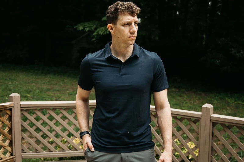 model in blue polo in backyard