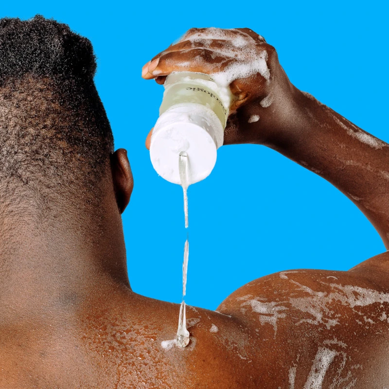 African American Man Applying Geologie Acne Control Superclean Body Wash on His Back