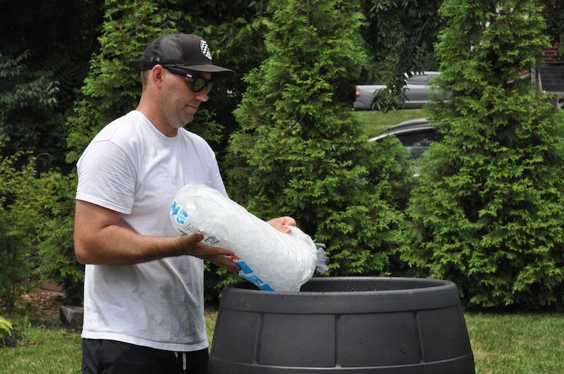 Male model filling Ice Barrel up with ice