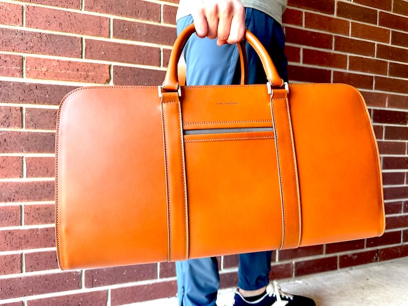 Male model holding Carl Friedrik Palissy Weekend bag
