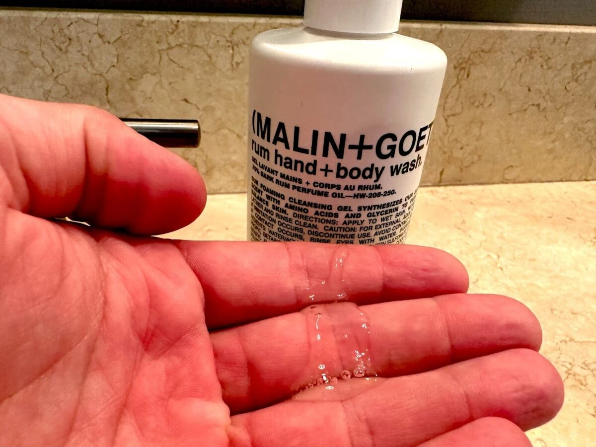 MalinGoetz skincare body wash in hand
