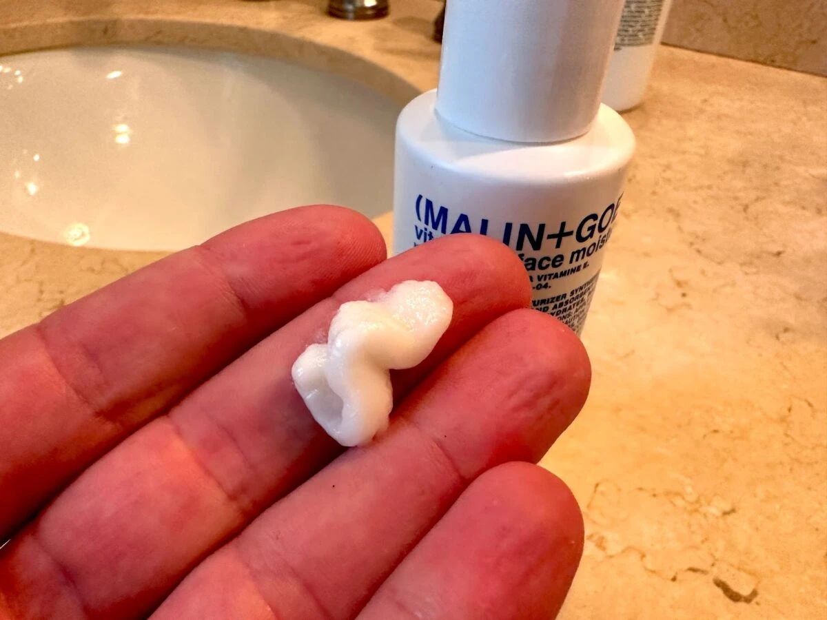 MalinGoetz skincare vitamin e moisturizer in hand