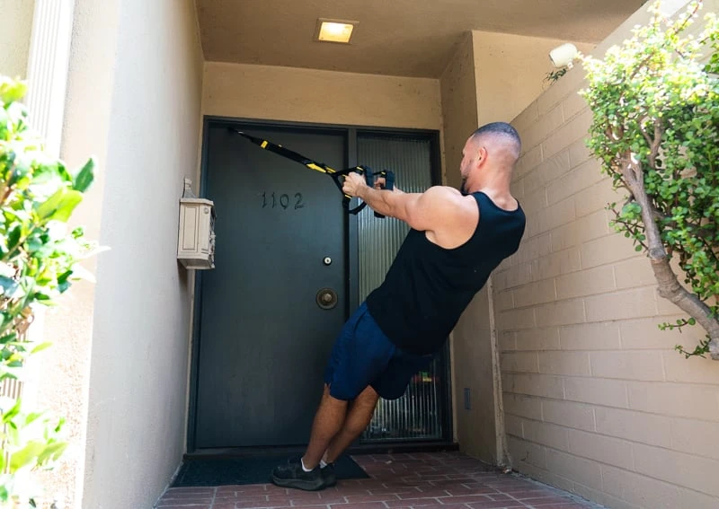 Man outdoors using TRX