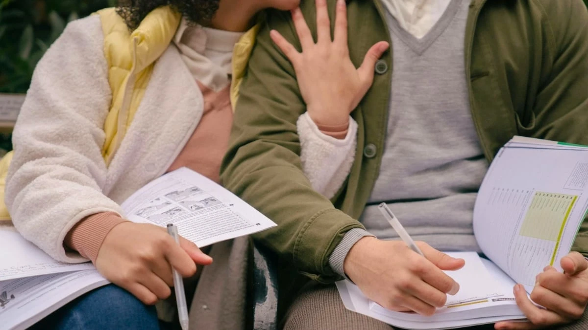 The Adult Man How to Date in College Advice for Guys by a Dating Coach Couple with Books Cuddling on Bench