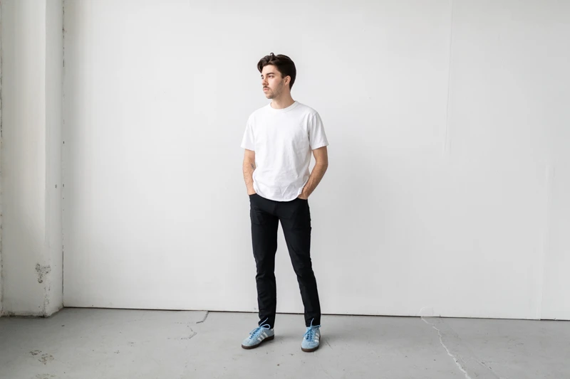 Vuori Meta Pant with sneakers and white tee from front