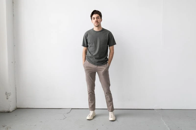 Vuori Optimist Pant model wearing tan shoes and green shirt