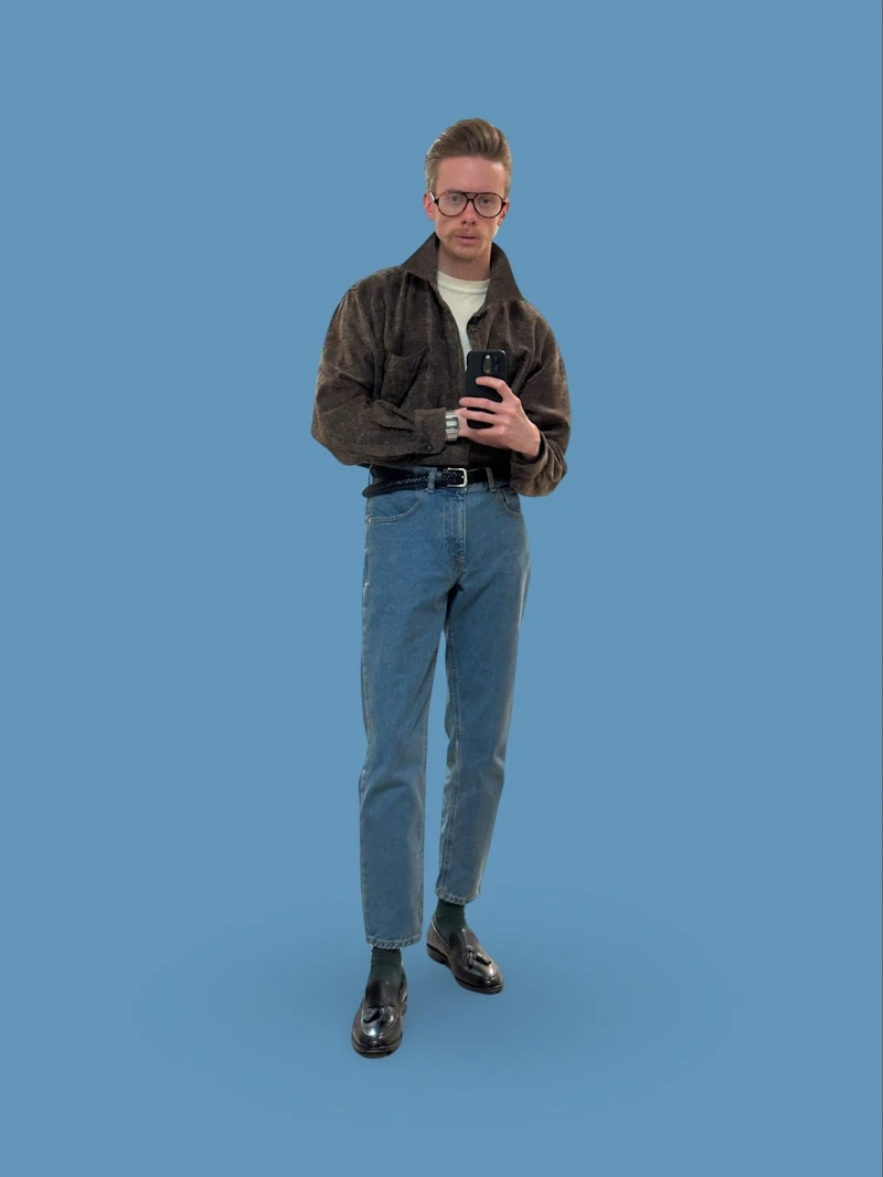 Model Posing wearing black shirt and blue jeans