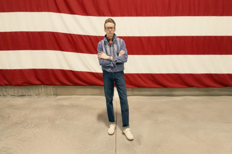 Photo of Model Posing Cross Armed in front of striped wall