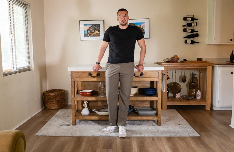 Model leaning on counter in ABC Classic fit Trouser
