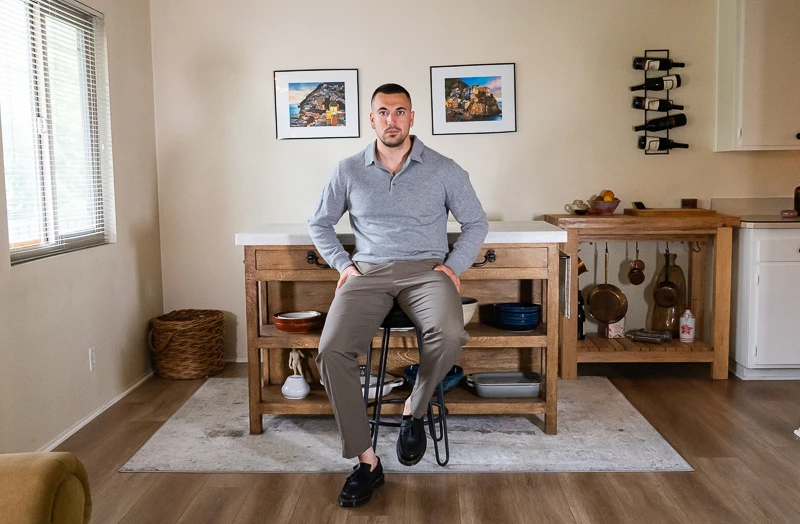 Model seated in the ABC Classic fit Trouser