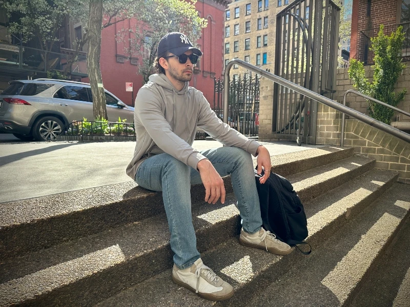 The Adult Man Cozy Earth Bamboo Hoodie Sitting on Steps 800