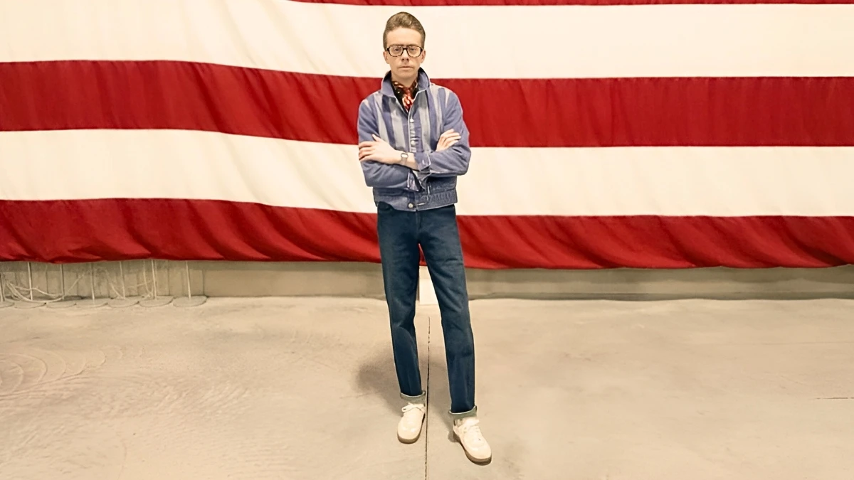 The-Adult-Man-How-to-Dress-as-a-Short-Guy-model-in-Denim-Standing-in-Front-of-American-Flag