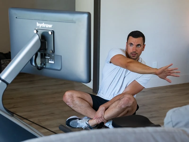 Model doing Hydrow yoga workout pose